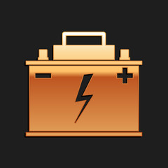 Gold Car battery icon isolated on black background. Accumulator battery energy power and electricity accumulator battery. Lightning bolt symbol. Long shadow style. Vector.