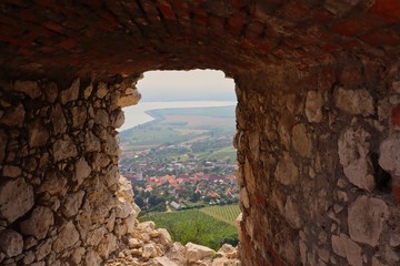 View of Village Pavlov from Window of Ruins of Devicky Castle in Palava Protected Landscape Area. Rock Window with the View of Rural Village in South Moravia, Czech Republic.