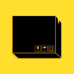 Black Carton cardboard box with traffic symbols icon isolated on yellow background. Delivery and packaging. Transportation and shipping. Long shadow style. Vector.