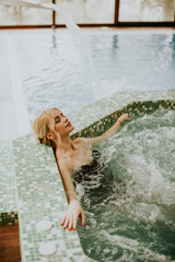 Young woman relaxing in the whirlpool bathtub