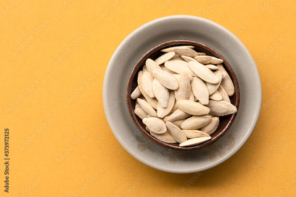 Wall mural roasted salted pumpkin seeds in a bowl