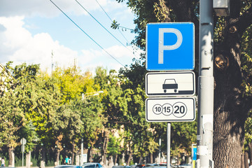 Fototapeta premium Isolated Parking Sign - Blue road sign with letter P on rectangular plate isolated against a blue sky.