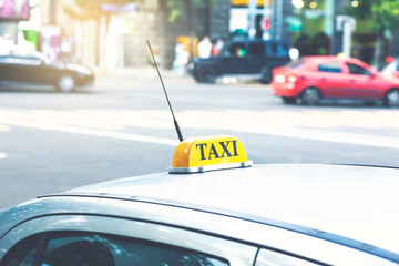 yellow taxi sign by taxi car in the afternoon or morning on city street