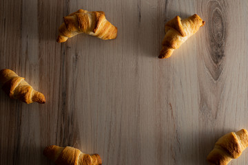 croissants on wooden background