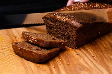 Homemade black bread on a black background. Photo in section.