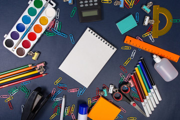 Back to school. School subjects on the blue table.