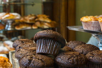 Chocolate cupcake in window of traditional sweet and pastry shop