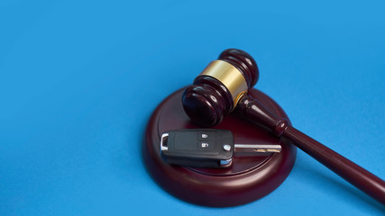 Driver license revocation concept next to the judge hammer. Traffic violation concept by car next...