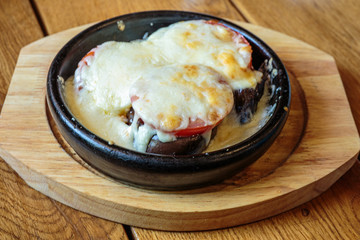 Eggplants  in a frying pan, baked with vegetables and cheese. Dish of Mediterranean cuisine. Restaurant shooting