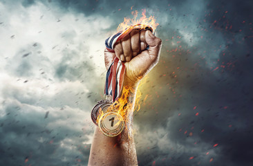 Medal for the first place on sky background. Victory concept. Fire and energy