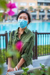 Fototapeta premium Asian woman wearing face mask in outdoors shopping mall