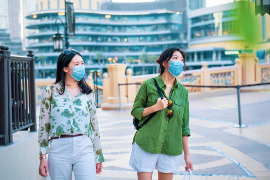 Two Female Friends Asian Woman Wearing Face Mask In Outdoors Shopping Mall