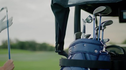 Sportsman Woman Takes Out Golf Club From Bag.