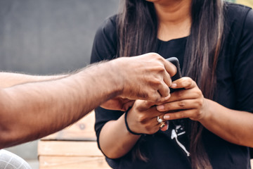 Irritated boyfriend pulls smartphone from girlfriend's hands, annoyed with his technology addiction, demands attention and care