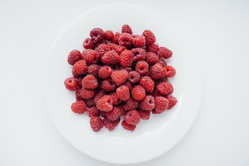 Red raspberry berries close-up on a white background. Healthy food, natural vitamins. Fresh berries