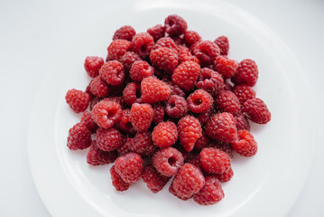 Red raspberry berries close-up on a white background. Healthy food, natural vitamins. Fresh berries