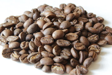 Coffee beans on the white background. Grains for making a drink coffee
