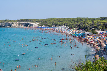 Top view of "Torre dell'Orso" beach full of bathers along the coast of Salento (Lecce,  Puglia, Italy). © Giongi63