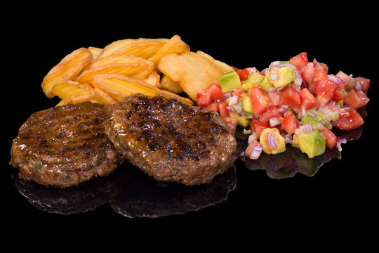 Delicious beef steak garnished with boiled potatoes and fresh salad, with reflection
