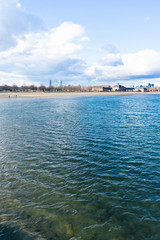 Fototapeta premium Boston skyline vertical view from the harbor point ocean waters showing the city behind