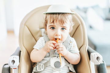 Baby boy eating and playing
