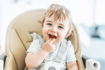 Baby boy eating and playing