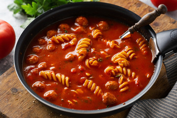 Italian tomato soup with meatballs and noodles