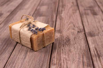 Bars of natural herbal handmade soap with lavender extract on natural wooden background with copyspace. Home spa treatments. Natural cosmetics concept