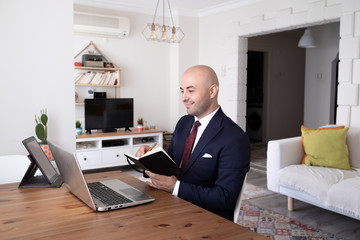 young man working remotely with leptop at his home. Distance Learning.