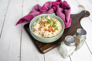 Shredded chicken in cream cheese sauce and bacon cooked in slow cooker