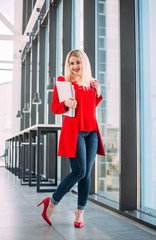Attractive successful business lady in a red suit