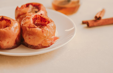 Baked apples with honey, on a white plate. Healthy food