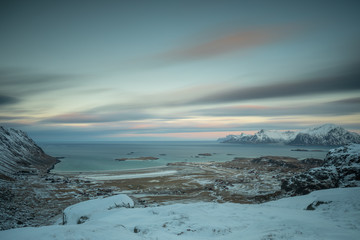 Winter panorama shot from Ryten peak towards Fredvang and Ramberg during blue hour. Lofoten, Norway