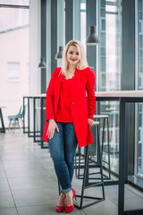 Obraz premium Attractive successful business lady in a red suit