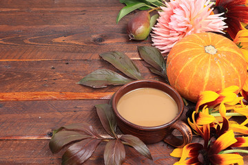 Autumn flower arrangement, abstract background flat lay, minimal holiday concept. Thanksgiving card with pumpkin, coffee and flowers, place for text,