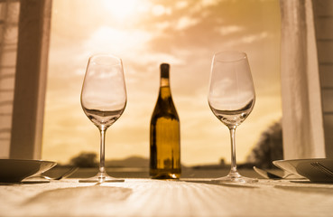 table setting at restaurant with wine and sunset view