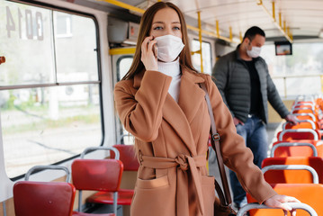 Naklejka premium Passengers on public transport during the coronavirus pandemic keep their distance from each other. Protection and prevention covid 19