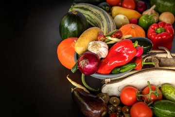 Fresh vegetables and old kitchen scale on a black background. Harvest of vegetables. Healthy food.