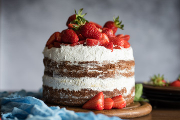 Chocolate and cream naked cake decorated with strawberries