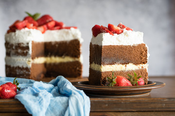 Sliced homemade chocolate naked cake with strawberries.
