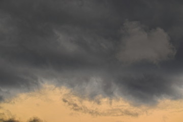 stormy clouds in varying shades of gray, floating under the dusk sky.