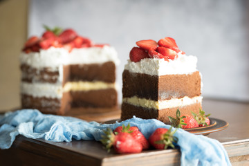Sliced homemade chocolate naked cake with strawberries.