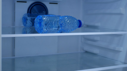 A Bottle with Fresh and Cold Water in the Kitchen Fridge