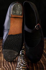 close up on tap shoe, black background, short depth of field.