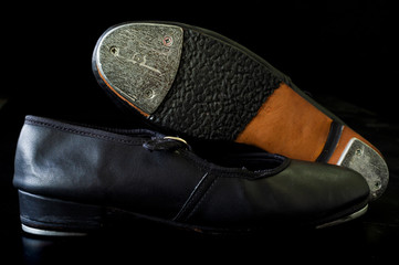 close up on tap shoe, black background, short depth of field.