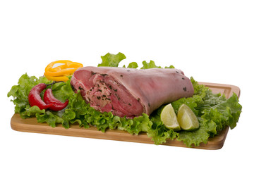 raw pork shank on cutting board on white background