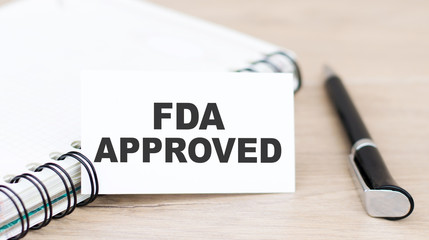 card with FDA APPROVED on the desktop