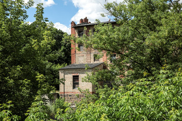 An old watermill on the river in summer.