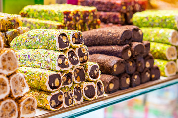 Various bright colored turkish delights sweets baklava lokum and dried fruits vegetables on market...