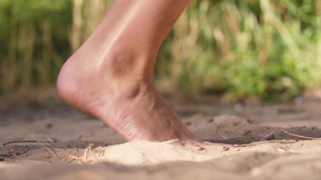 woman walks with barefeet in sand